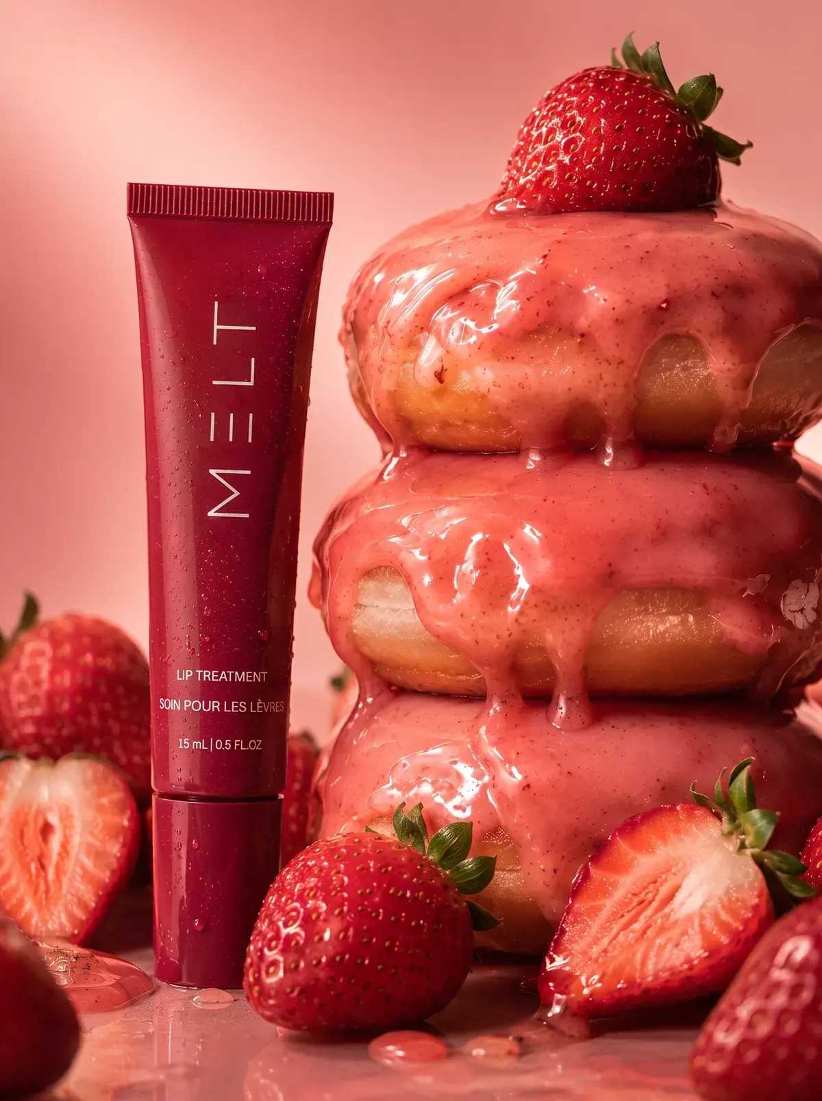 The MELT tube stands beside a stack of strawberry-glazed doughnuts.